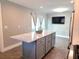 Modern kitchen island with granite countertops and gray cabinets, perfect for entertaining at 1818 Douglas Ave, Dunedin, FL 34698
