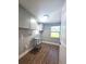 A functional laundry room featuring ample cabinet space and natural light from the window at 1818 Douglas Ave, Dunedin, FL 34698