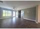 Bright living room featuring tiled floors, modern fan, a sliding barn door, and neutral paint at 1818 Douglas Ave, Dunedin, FL 34698