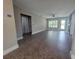 Spacious living room featuring neutral paint, tiled floors, modern fan and a sliding barn door at 1818 Douglas Ave, Dunedin, FL 34698