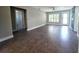 Expansive living room with tile floors, lots of natural light, and convenient access to a bathroom at 1818 Douglas Ave, Dunedin, FL 34698