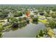 Aerial view of home with lake access, mature trees and lush backyard at 18408 Hanna Rd, Lutz, FL 33549
