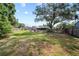 Spacious backyard with mature trees and plenty of space for recreation and relaxation at 18408 Hanna Rd, Lutz, FL 33549