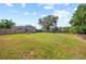 Expansive backyard with lush green lawn, mature trees, and inviting outdoor spaces at 18408 Hanna Rd, Lutz, FL 33549