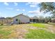 Large backyard featuring a screened in patio and a play set at 18408 Hanna Rd, Lutz, FL 33549