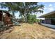 Large backyard with mature trees, playground and enclosed patio at 18408 Hanna Rd, Lutz, FL 33549