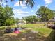 Expansive backyard with lake, fire pit, and mature trees, perfect for outdoor activities at 18408 Hanna Rd, Lutz, FL 33549