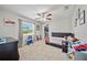 Cozy bedroom with a window offering natural light and organized closet at 18408 Hanna Rd, Lutz, FL 33549