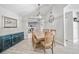 Dining room with modern lighting, elegant decor, and views into kitchen at 18408 Hanna Rd, Lutz, FL 33549