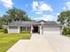 Charming single-story home with a well-manicured lawn and a spacious two-car garage at 18408 Hanna Rd, Lutz, FL 33549