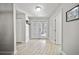 Bright foyer with wood-look tiled flooring and an abundance of natural light from the front doors at 18408 Hanna Rd, Lutz, FL 33549
