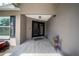 Inviting front porch with tiled floor leading to double front doors and gray exterior at 18408 Hanna Rd, Lutz, FL 33549