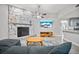 Bright living room with stone fireplace and view to the kitchen area at 18408 Hanna Rd, Lutz, FL 33549