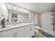 Main bathroom with double vanity, tiled shower, and modern fixtures at 18408 Hanna Rd, Lutz, FL 33549