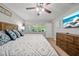 Comfortable main bedroom with a ceiling fan, wood furniture, and natural light at 18408 Hanna Rd, Lutz, FL 33549