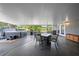 Covered patio boasting a hot tub, outdoor dining set, and a tranquil view at 18408 Hanna Rd, Lutz, FL 33549