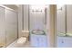 Bright bathroom featuring tiled walls, glass shower, and modern vanity with glass countertop at 1849 Abrico Dr # K9, Lutz, FL 33558