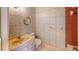 Bathroom featuring neutral tiled walls, gold fixtures and decorative mirror at 1849 Abrico Dr # K9, Lutz, FL 33558