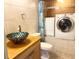 Bathroom featuring modern vessel sink, built-in laundry, and tile flooring at 1849 Abrico Dr # K9, Lutz, FL 33558