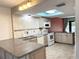 Bright kitchen featuring granite countertops, stainless steel appliances, and an eat-in island at 1849 Abrico Dr # K9, Lutz, FL 33558
