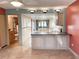 Open-concept kitchen with granite countertops, eat-in island, and an adjacent full bathroom at 1849 Abrico Dr # K9, Lutz, FL 33558