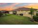 Spacious backyard with lush lawn, outdoor seating, and mature landscaping perfect for relaxation and entertaining at 20254 Ravens End Dr, Tampa, FL 33647