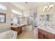 Luxurious bathroom featuring dual sinks, a soaking tub, and a separate shower at 20254 Ravens End Dr, Tampa, FL 33647
