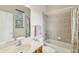 Bathroom with vanity, tub with shower, and window providing natural light at 20254 Ravens End Dr, Tampa, FL 33647