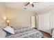 Cozy bedroom with ceiling fan, closet, and views to the hallway with en-suite bathroom at 20254 Ravens End Dr, Tampa, FL 33647