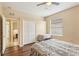 Bedroom features wood floors, a closet, views to the hall and a side window at 20254 Ravens End Dr, Tampa, FL 33647