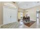 Inviting dining area with natural light, wood floors, a chandelier, and a view of the front entry at 20254 Ravens End Dr, Tampa, FL 33647