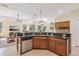 Well-equipped kitchen featuring wood cabinets, black granite countertops, and stainless steel appliances at 20254 Ravens End Dr, Tampa, FL 33647