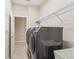 Well-equipped laundry room featuring sleek, front-load washer and dryer, ample shelving, and a utility sink at 20254 Ravens End Dr, Tampa, FL 33647
