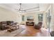 Cozy living room featuring hardwood floors, a ceiling fan, and a flat-screen TV for entertainment at 20254 Ravens End Dr, Tampa, FL 33647