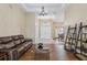 Spacious living room with hardwood floors, coffered ceiling, chandelier and a view into the dining room at 20254 Ravens End Dr, Tampa, FL 33647