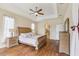 Serene main bedroom featuring a ceiling fan, hardwood floors, and a light color palette at 20254 Ravens End Dr, Tampa, FL 33647