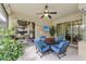 Inviting screened patio with comfortable seating, ceiling fan, and views of the landscaped backyard at 20254 Ravens End Dr, Tampa, FL 33647