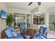 Inviting covered patio with comfortable seating, ceiling fan, and sliding glass doors to the interior at 20254 Ravens End Dr, Tampa, FL 33647