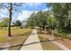 Scenic walking path meandering through a picturesque park with mature trees and comfortable benches at 20254 Ravens End Dr, Tampa, FL 33647