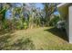 Lush backyard featuring mature trees and landscaping, offering privacy and natural beauty at 2042 Craft Ln, Sarasota, FL 34239
