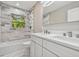 Bathroom with double sink, marble floors and tiled walls is luxurious and modern at 2042 Craft Ln, Sarasota, FL 34239