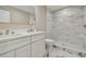 Bathroom with double sink, marble floors and tiled walk-in shower is luxurious and modern at 2042 Craft Ln, Sarasota, FL 34239