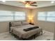 Bright bedroom with two windows, a comfortable bed, a nightstand, and stylish marble floors at 2042 Craft Ln, Sarasota, FL 34239