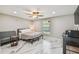 Bedroom with a ceiling fan and marble floors offering a modern look to this cozy space at 2042 Craft Ln, Sarasota, FL 34239