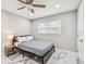 Serene bedroom with a ceiling fan, white marble floors, and a large window for natural light at 2042 Craft Ln, Sarasota, FL 34239