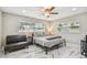 Bright bedroom with stylish marble floors, a ceiling fan, and lots of natural light from the window at 2042 Craft Ln, Sarasota, FL 34239