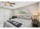 Comfortable bedroom featuring marble floors, a ceiling fan, and neutral walls, creating a cozy retreat at 2042 Craft Ln, Sarasota, FL 34239
