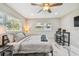 Bedroom with marble flooring, ceiling fan, and natural light from the windows offering a relaxing and inviting space at 2042 Craft Ln, Sarasota, FL 34239