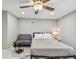 Cozy bedroom featuring a ceiling fan, marble floors, a side table, and a comfortable loveseat at 2042 Craft Ln, Sarasota, FL 34239