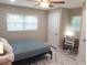 Well-lit bedroom with two windows, a work desk, and a comfortable bed at 2042 Craft Ln, Sarasota, FL 34239